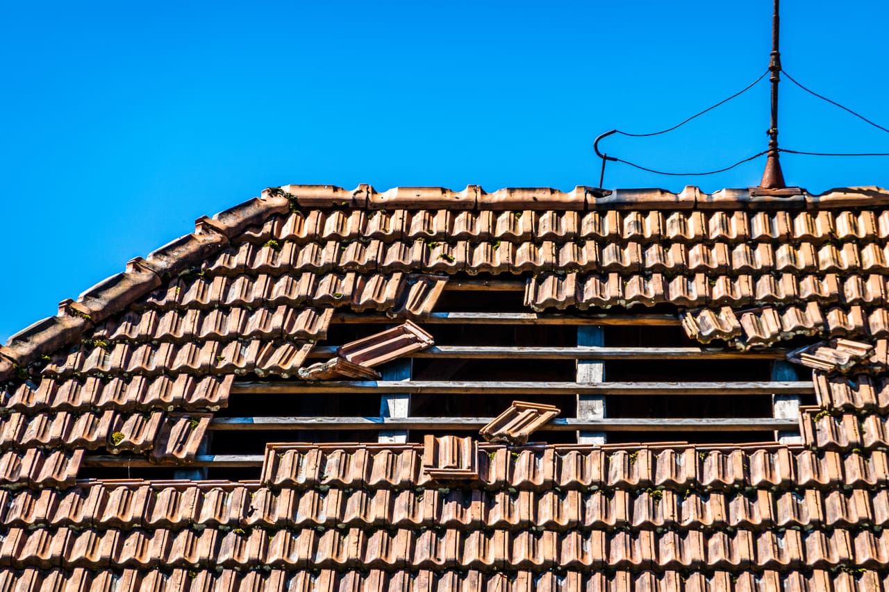 Emergency roofer making a storm-damaged roof safe in Berkshire