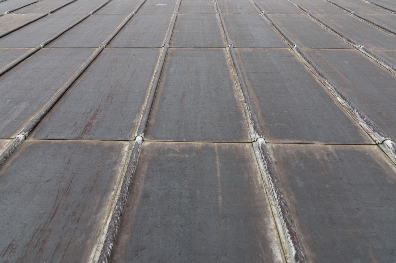 Roofer forming lead flashing on a roof detail in Berkshire