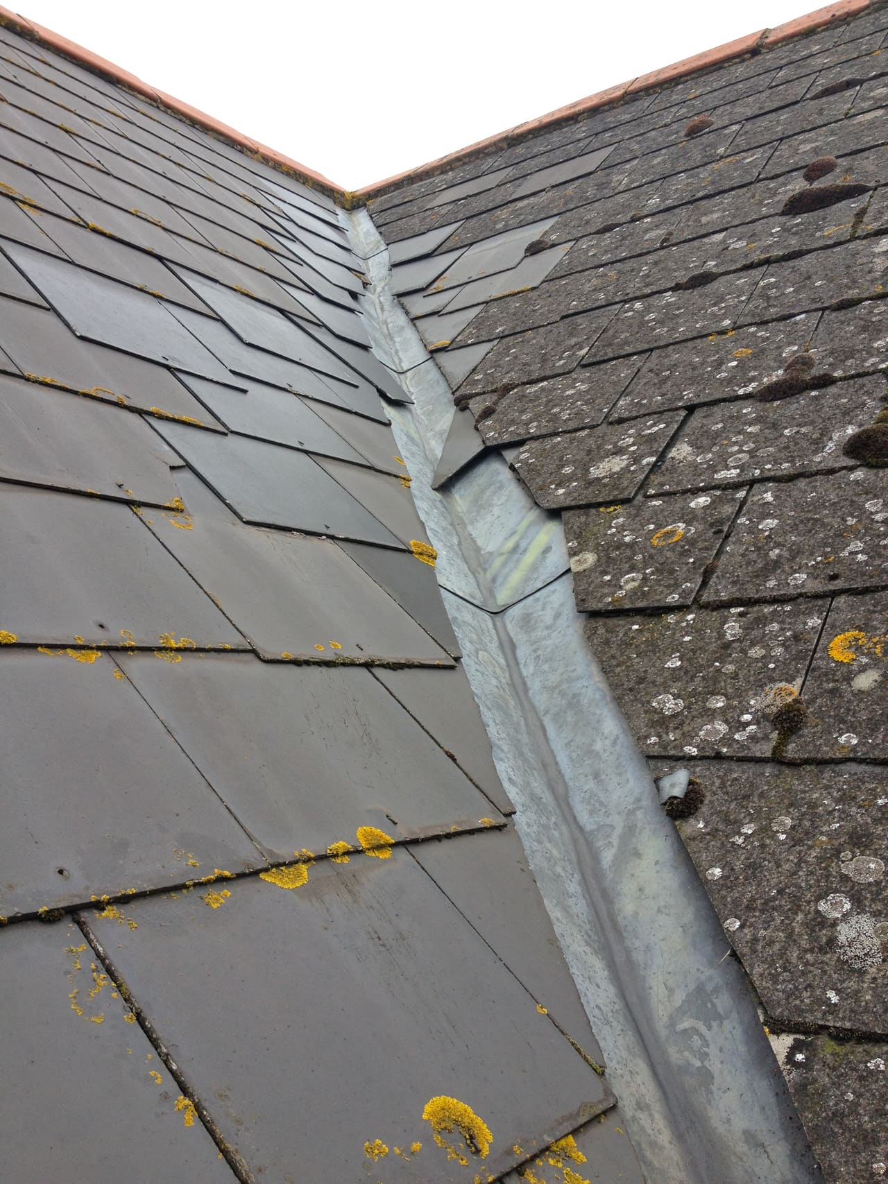 Moss being cleared from a tiled roof in Berkshire